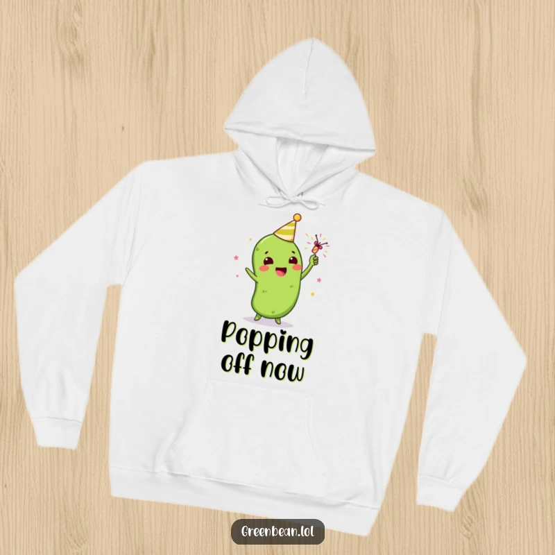 Funny hoodie featuring a gleeful green bean character celebrating with a tiny party popper, perfect for festive warmth.