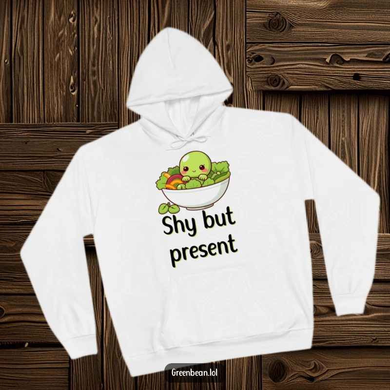 Funny Hoodie with a shy green bean character peeking from a salad bowl, perfect for cozying up.