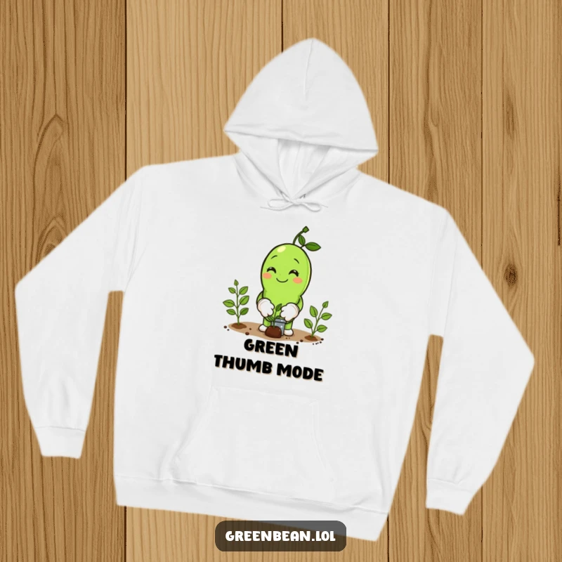 Funny Hoodie depicting a smiling green bean character wearing miniature gardening gloves and planting seeds, radiating garden enthusiasm.