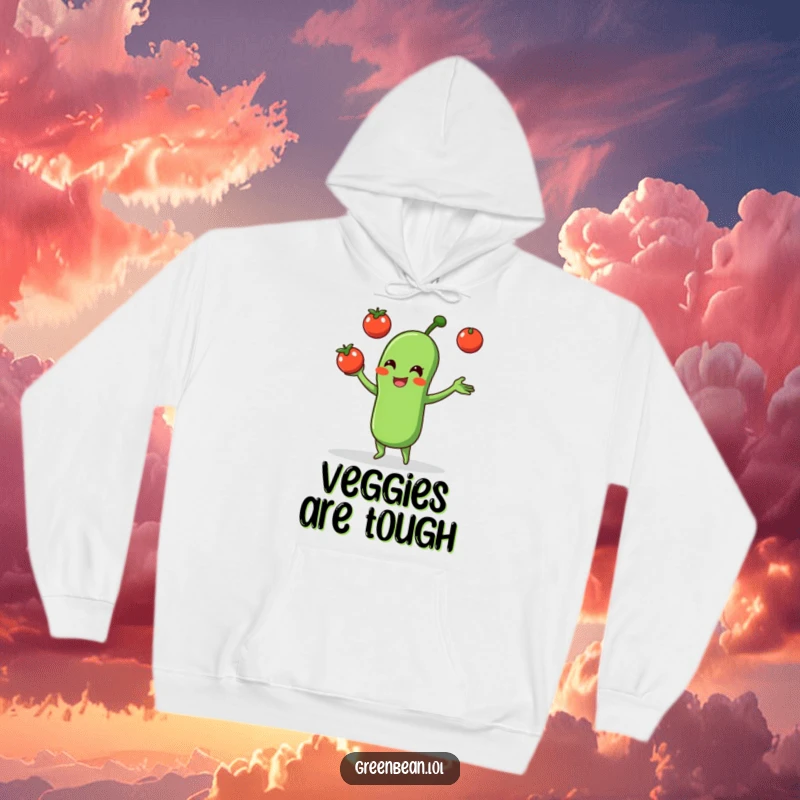 Funny hoodie showcasing a cheerful green bean juggling three small tomatoes, perfect for staying warm and amused.